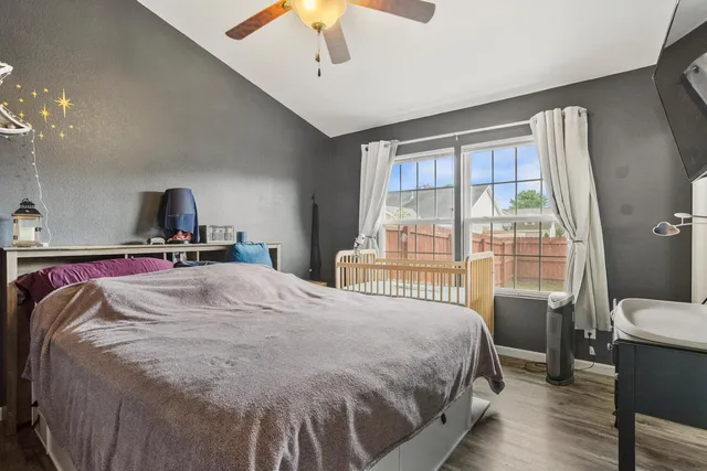 a bed sitting in a bedroom next to a window