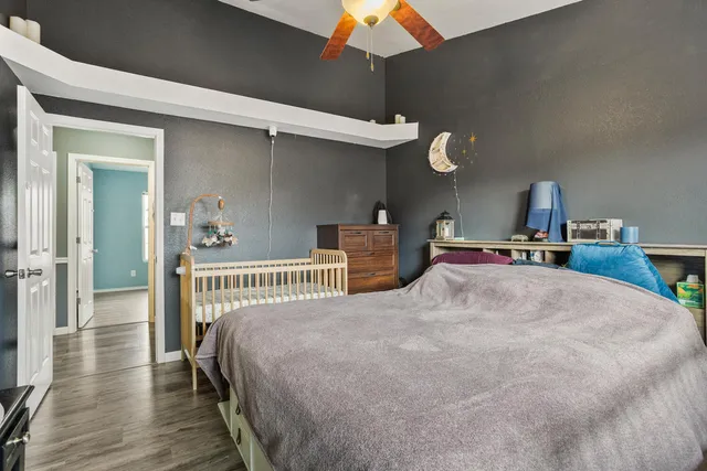 a bedroom with a bed and a chandelier