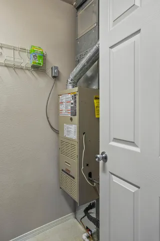 a room with water heater and a shower