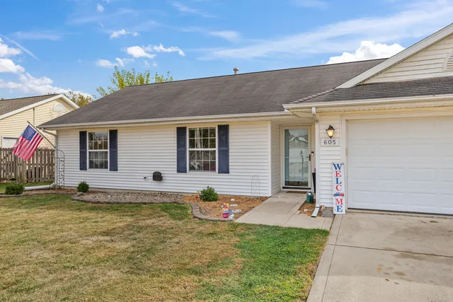 a view of a house with swimming pool and sitting area