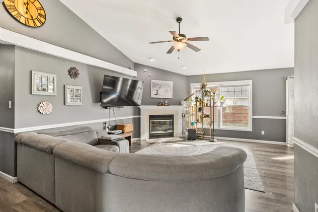 a living room with fireplace furniture and a flat screen tv