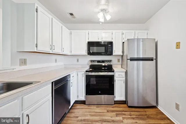 a kitchen with stainless steel appliances a refrigerator stove and microwave