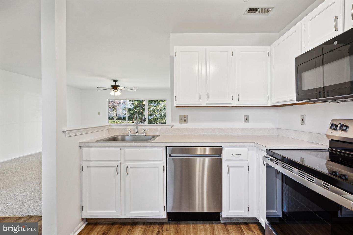 1107 Squirrel Road Marlton, NJ 08053 - Photo 14 of 24 a kitchen with stainless steel appliances granite countertop a sink and cabinets