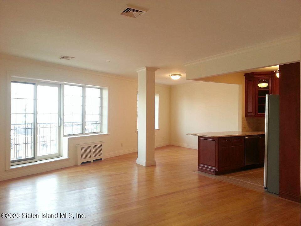 155 Bay Street, Unit 4F Staten Island, NY 10301 - Photo 3 of 6 a view of an empty room with window and wooden floor
