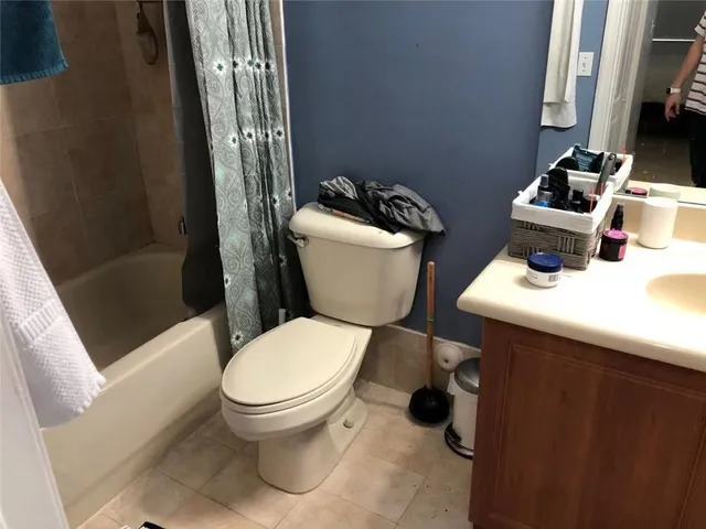 a bathroom with a toilet a sink and a mirror