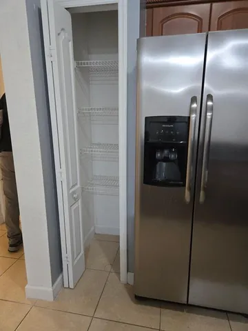a view of a refrigerator in kitchen