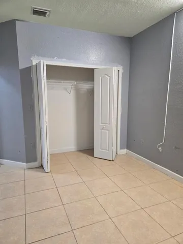 a view of an empty room with a door