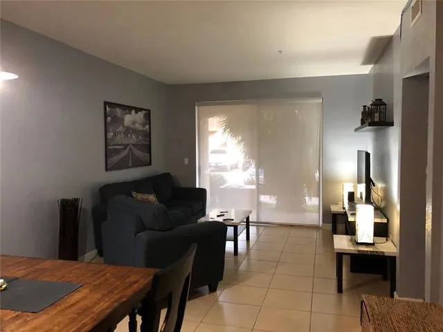 a living room with furniture a table and a painting