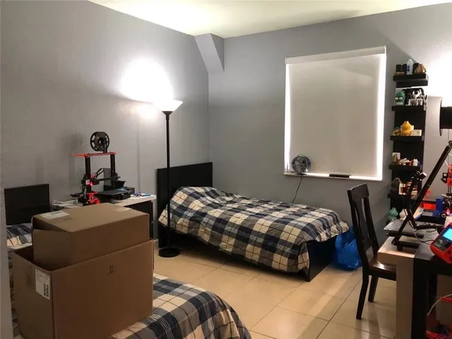 a bedroom with bed and a window