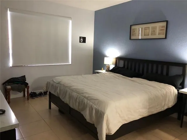 a bedroom with a bed and chair