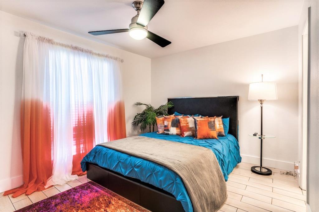 6014 East Mockingbird Lane Dallas, TX 75206 - Photo 13 of 17 a bedroom with a bed and a lamp