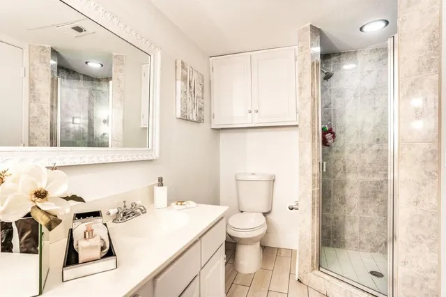 a bathroom with a sink toilet and shower