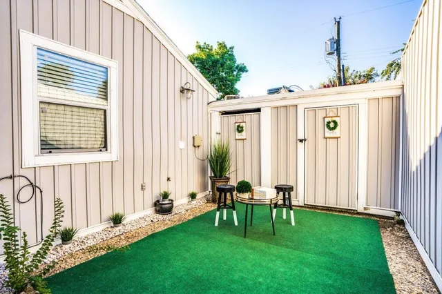 a backyard of a house with table and chairs