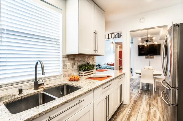 a kitchen with a sink and a stove top oven