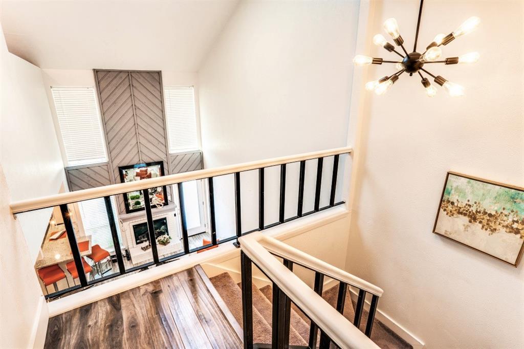6014 East Mockingbird Lane Dallas, TX 75206 - Photo 7 of 17 a view of a hallway with wooden floor and stairs