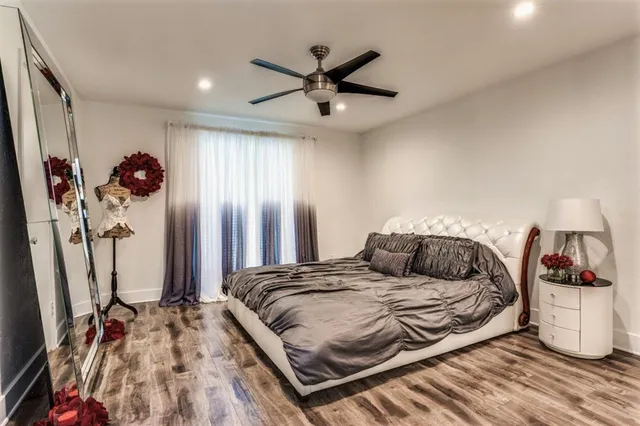 a bedroom with a bed and ceiling fan