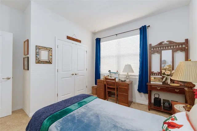 a bedroom with a bed and large windows