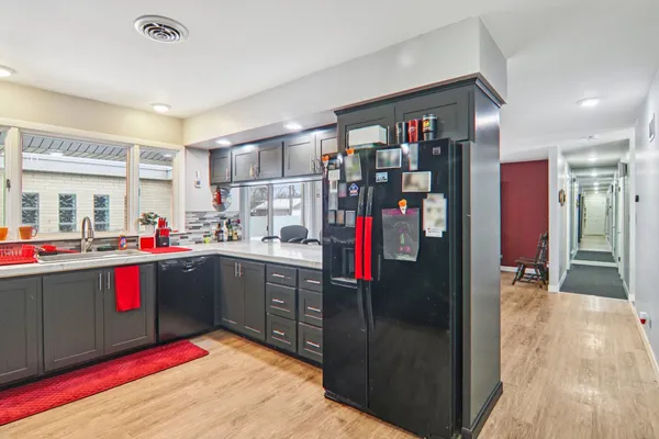 a kitchen with a refrigerator and a sink