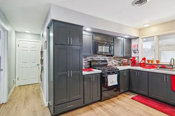 a kitchen with stainless steel appliances granite countertop a refrigerator and a stove