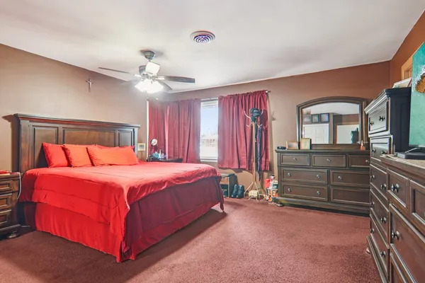 a bedroom with a bed and a chandelier
