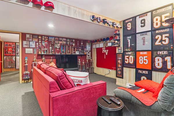 a living room with furniture and a bookshelf