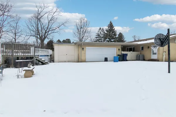a view of a house with a snow in the yard