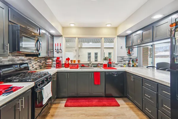 a kitchen with lots of appliances and cabinets