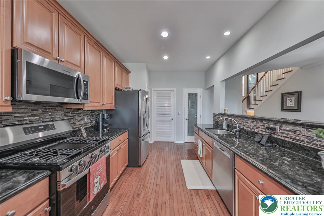 163 Muirfield Way Easton, PA 18042 - Photo 12 of 48 a kitchen with stainless steel appliances granite countertop a sink stove and refrigerator