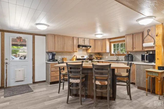 a kitchen with granite countertop a sink stainless steel appliances and cabinets