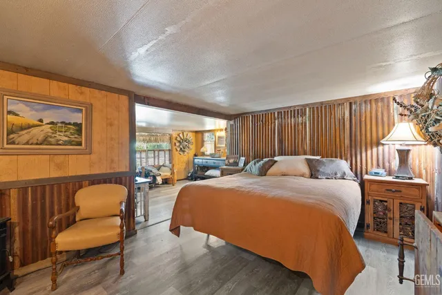 a bed room with furniture and a flat screen tv