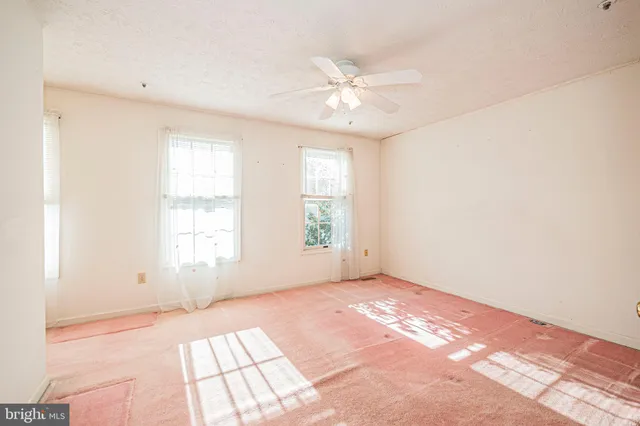 a bathroom with a toilet a sink and a window