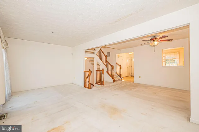 a view of an empty room with a fireplace