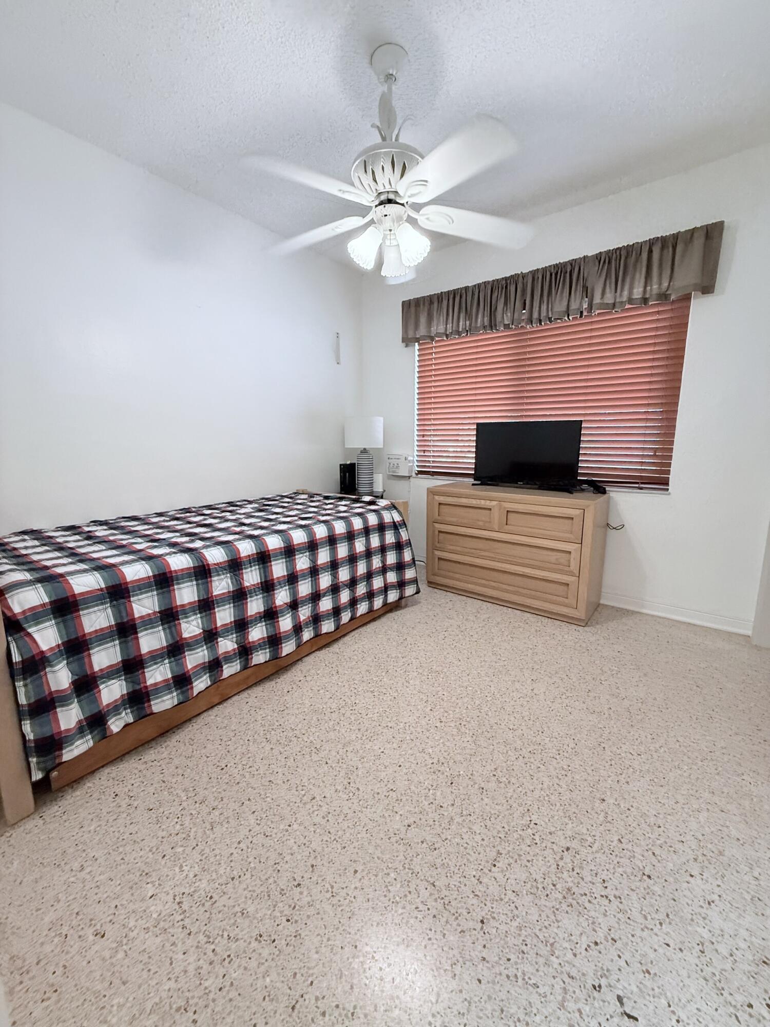 957 West 67th Street Hialeah, FL 33012 - Photo 12 of 15 a bedroom with furniture and a chandelier