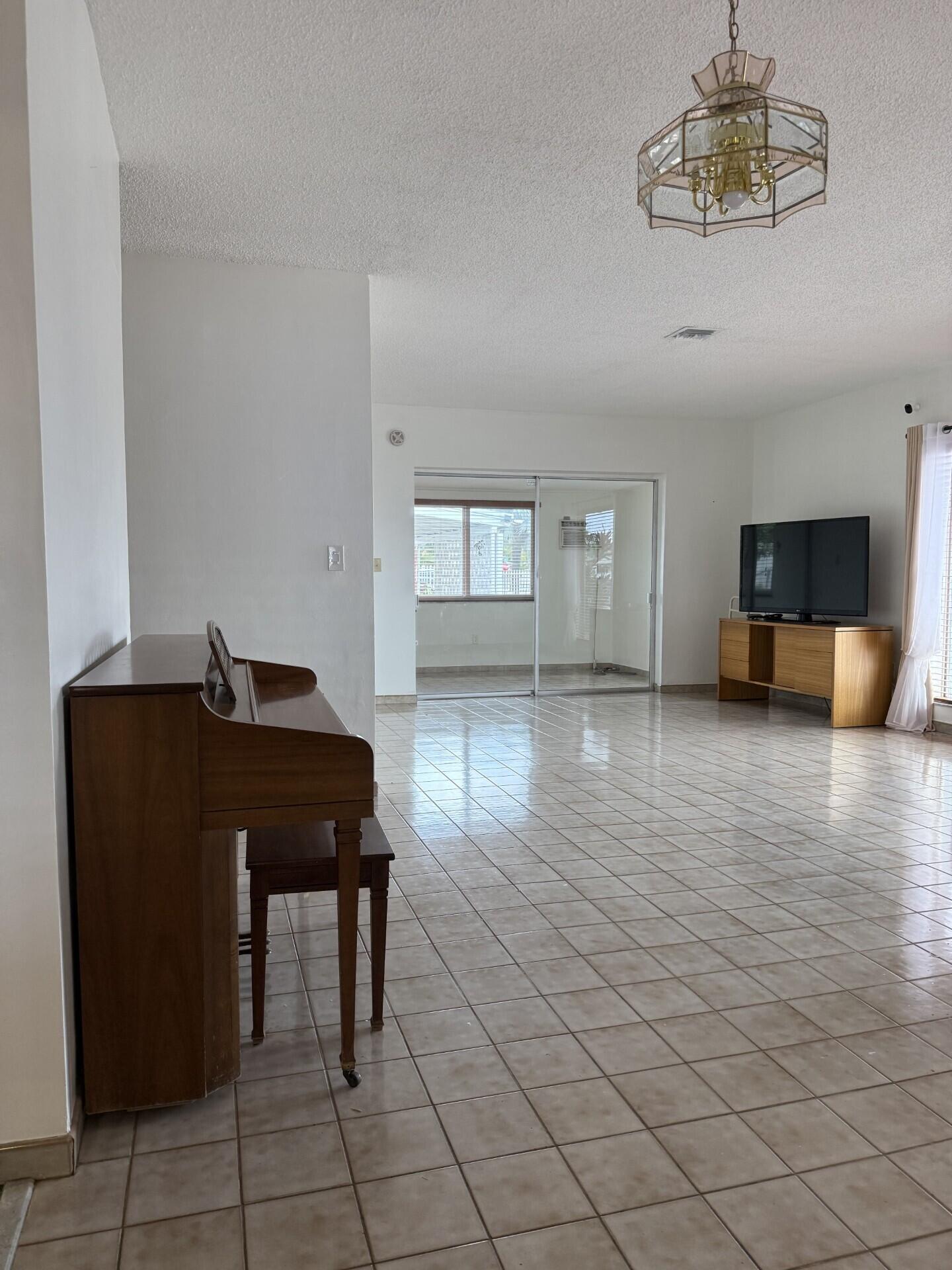957 West 67th Street Hialeah, FL 33012 - Photo 3 of 15 a room with furniture and wooden floor
