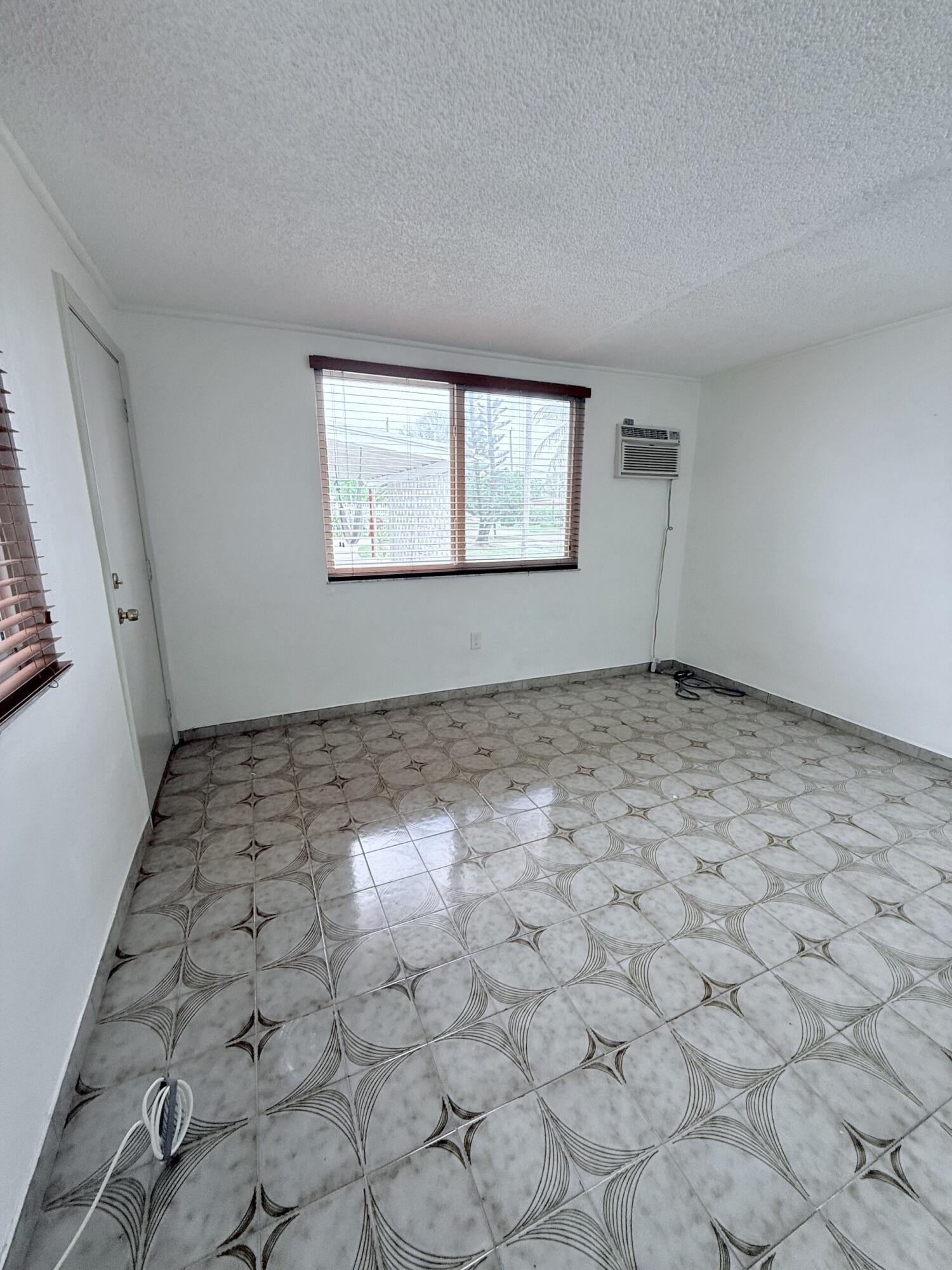957 West 67th Street Hialeah, FL 33012 - Photo 4 of 15 an empty room with windows