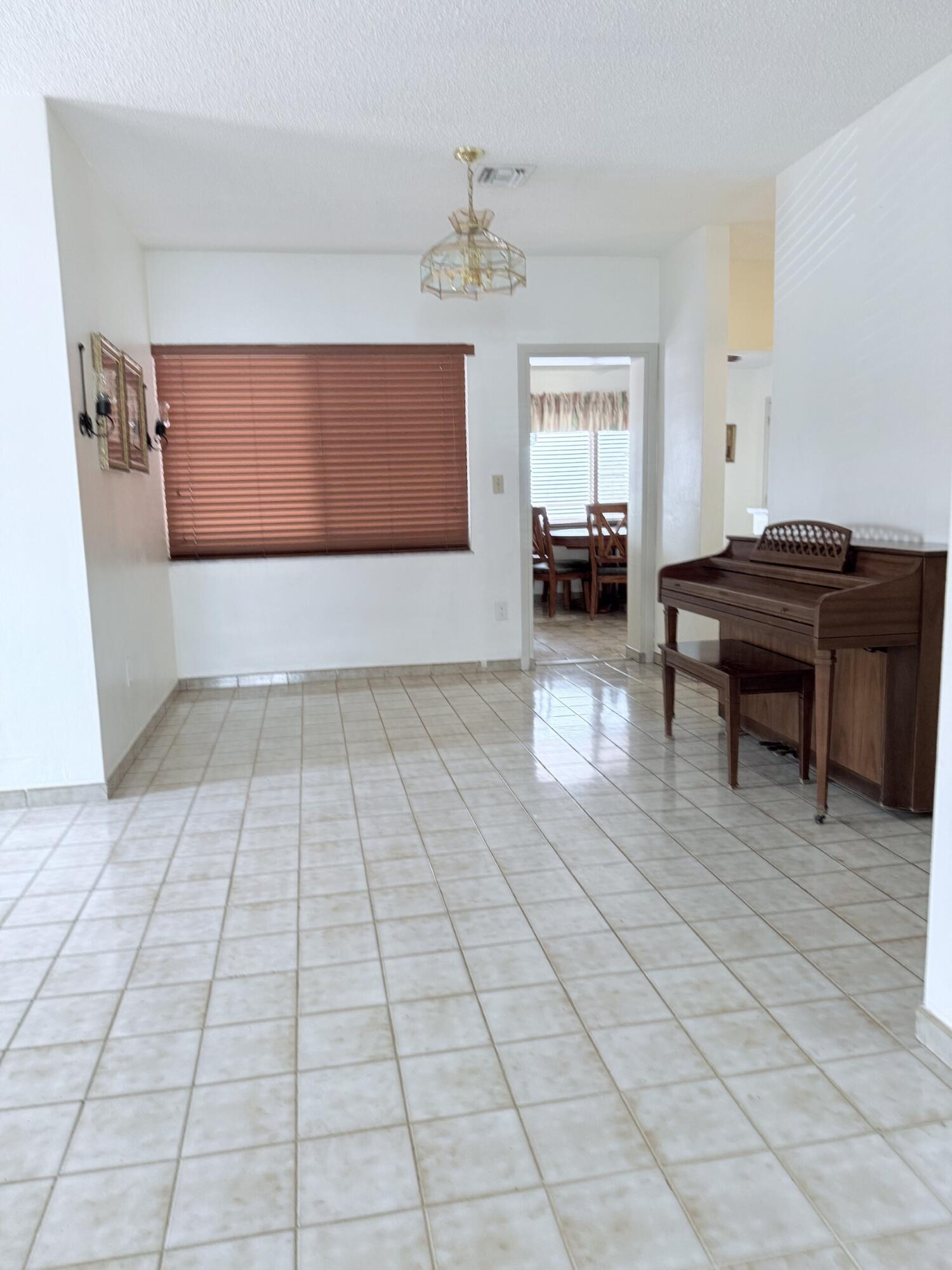957 West 67th Street Hialeah, FL 33012 - Photo 5 of 15 a living room with furniture and a window