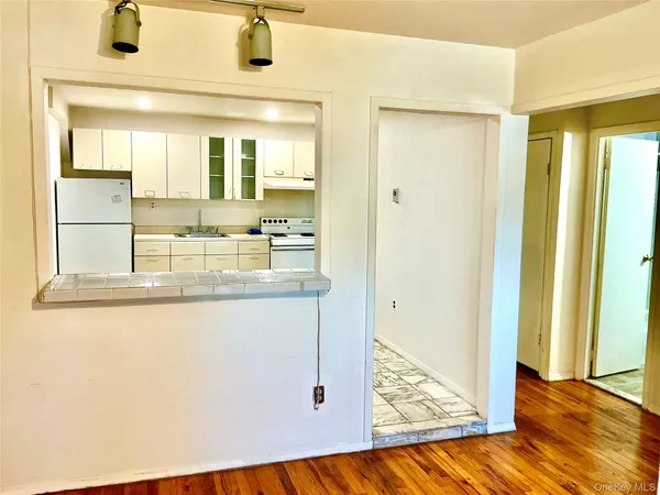 a view of bathroom with granite countertop shower a sink and a mirror