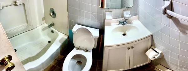 a bathroom with a sink toilet and mirror
