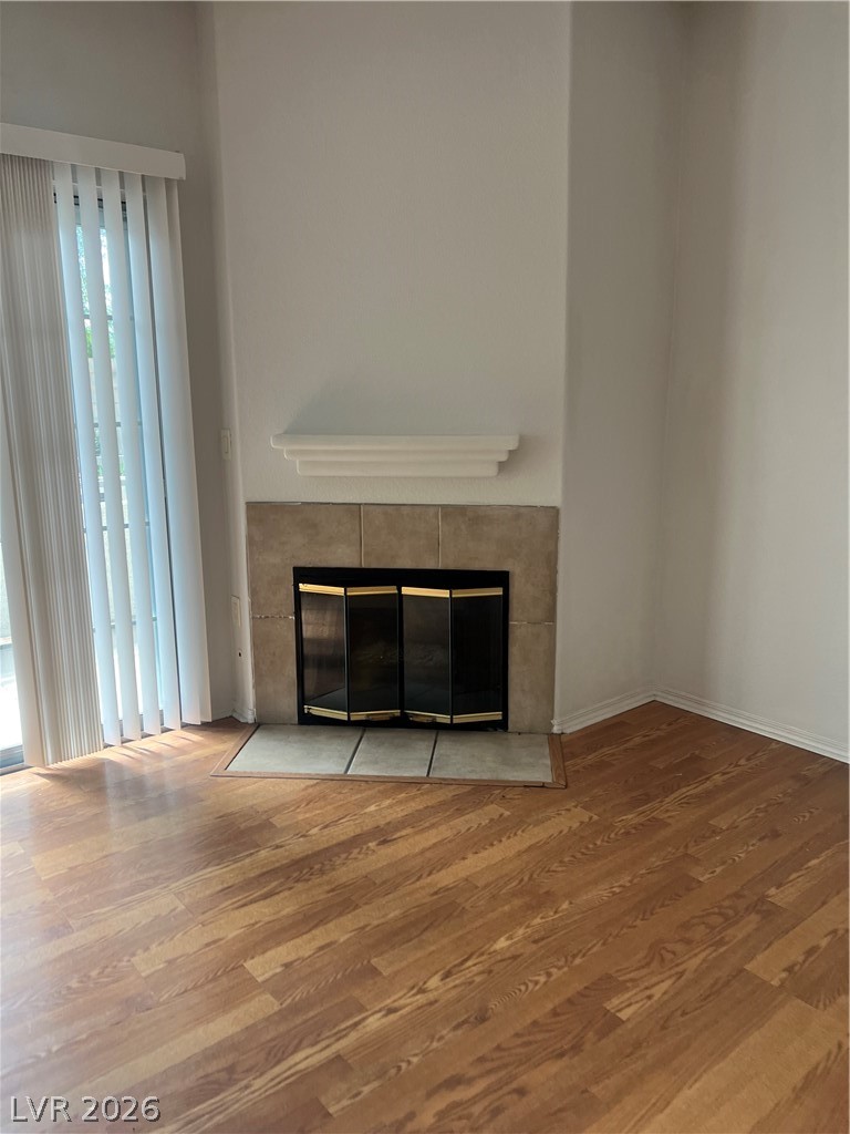 3318 North Decatur Boulevard, Unit 1174 Las Vegas, NV 89130 - Photo 3 of 23 This inviting space features a tiled fireplace and rich hardwood flooring.