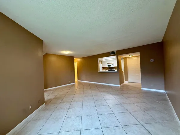 a view of an empty room and a window