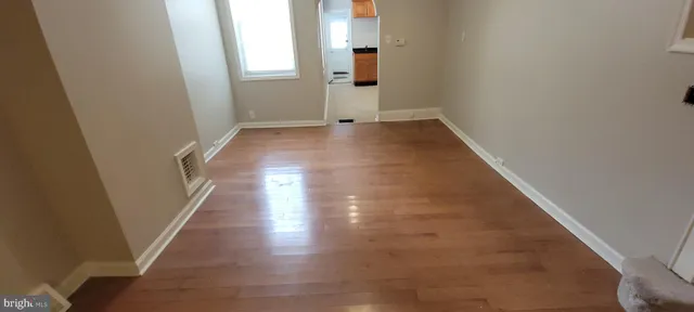 an entryway of a house with wooden floor and stairs