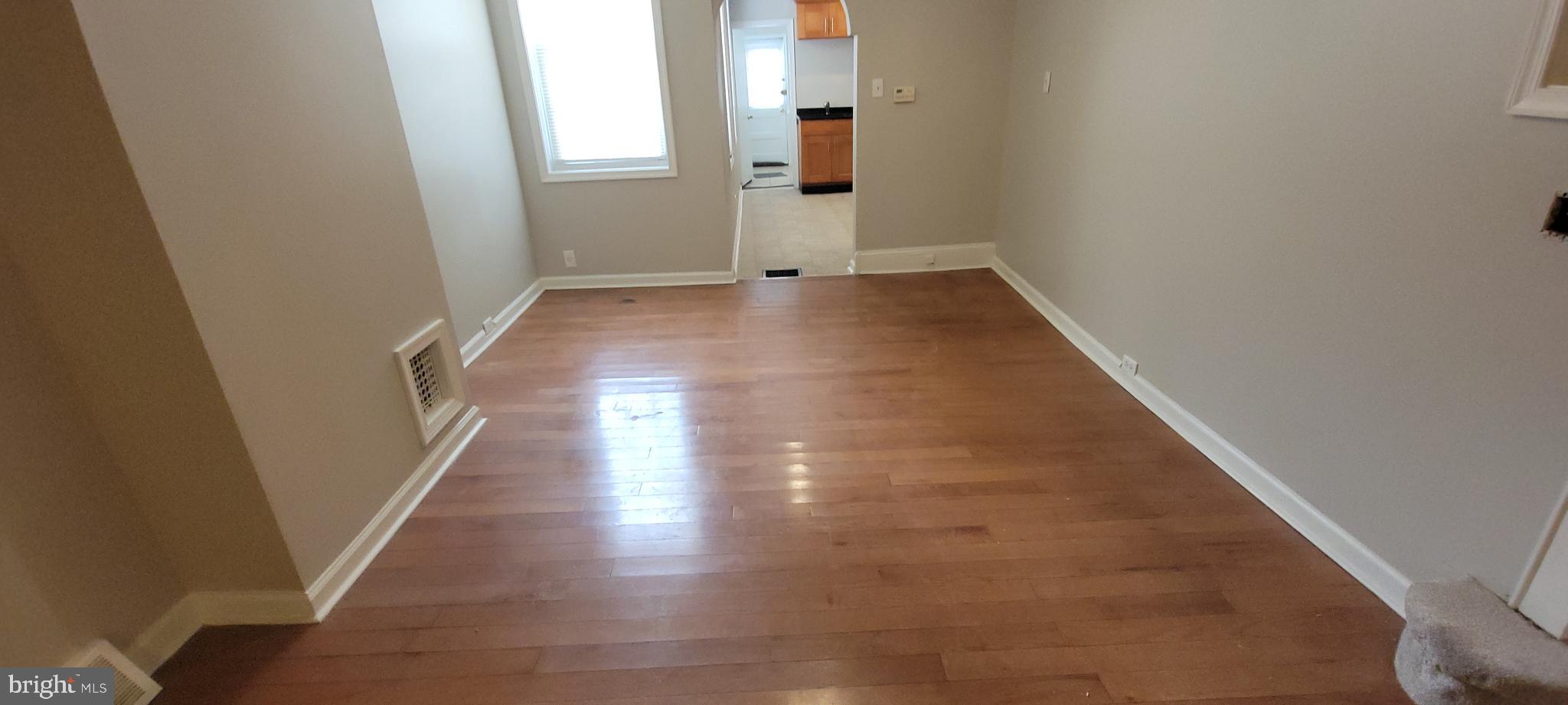 2643 Emerald Street Philadelphia, PA 19125 - Photo 8 of 14 an entryway of a house with wooden floor and stairs