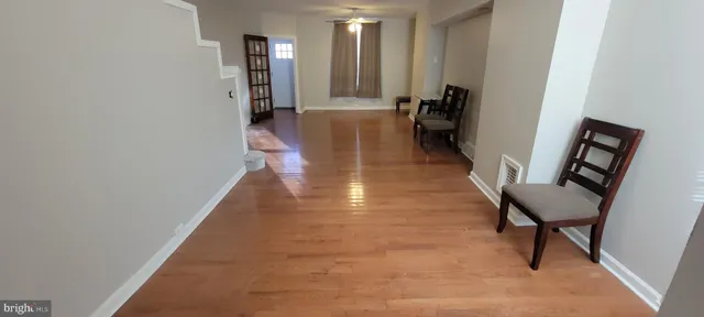 a hallway with wooden floor and furniture