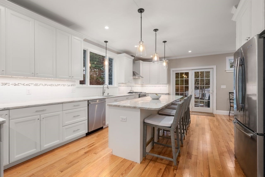 72 Great Plain Avenue Wellesley, MA 02482 - Photo 11 of 38 a kitchen with stainless steel appliances granite countertop a sink a stove a refrigerator and island with wooden floor
