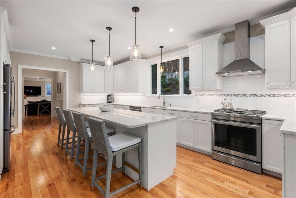 72 Great Plain Avenue Wellesley, MA 02482 - Photo 14 of 38 a kitchen with a stove a sink and a wooden floor