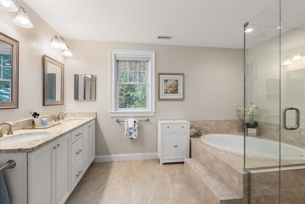 72 Great Plain Avenue Wellesley, MA 02482 - Photo 22 of 38 a spacious bathroom with a double vanity sink a mirror and a bathtub