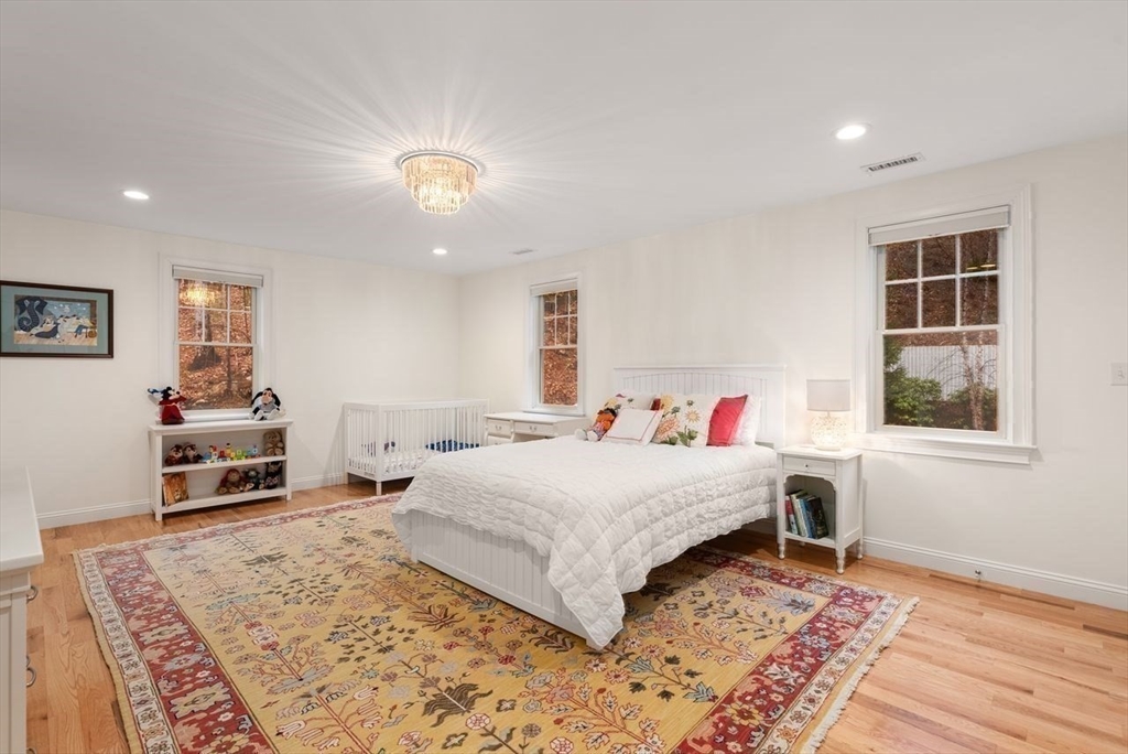 72 Great Plain Avenue Wellesley, MA 02482 - Photo 26 of 38 a bedroom with a large bed a rug and a window