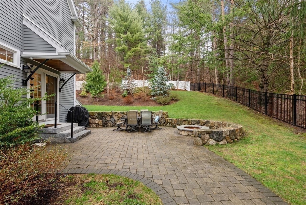 72 Great Plain Avenue Wellesley, MA 02482 - Photo 36 of 38 a view of a backyard with table and chairs and potted plants
