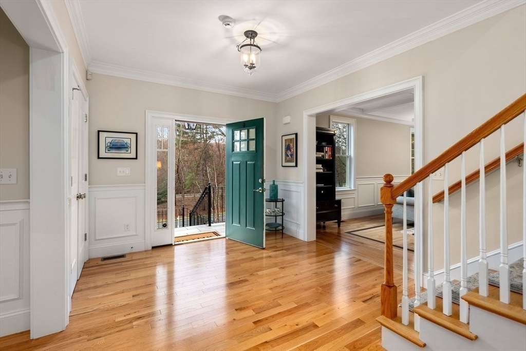 72 Great Plain Avenue Wellesley, MA 02482 - Photo 4 of 38 a view of a hallway with wooden floor and stairs