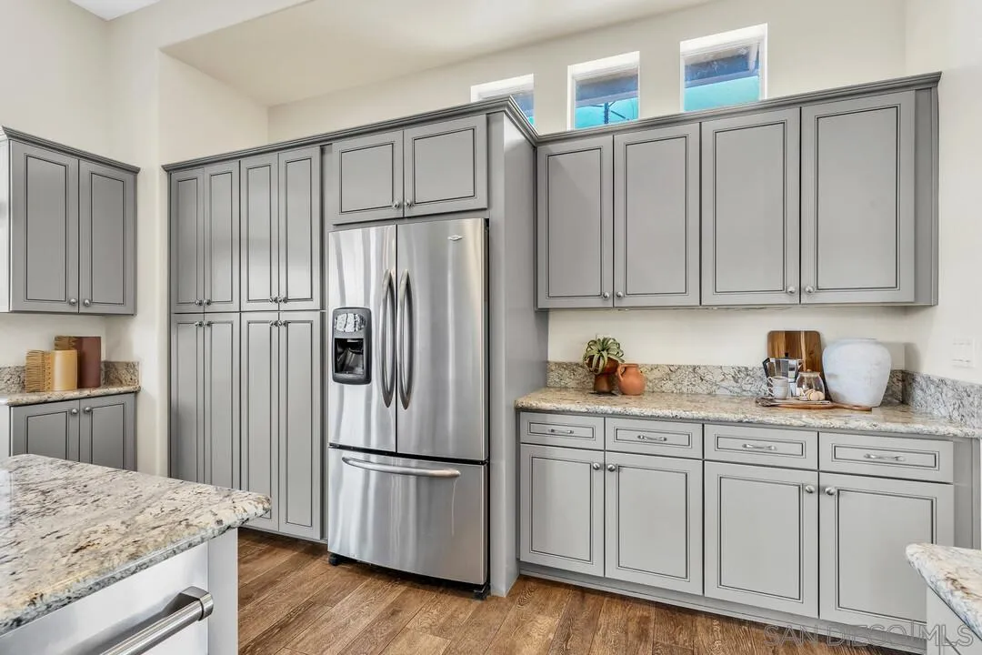 1198 Hanover Place Alpine, CA 91901 - Photo 23 of 68 a kitchen with granite countertop a refrigerator sink and cabinets